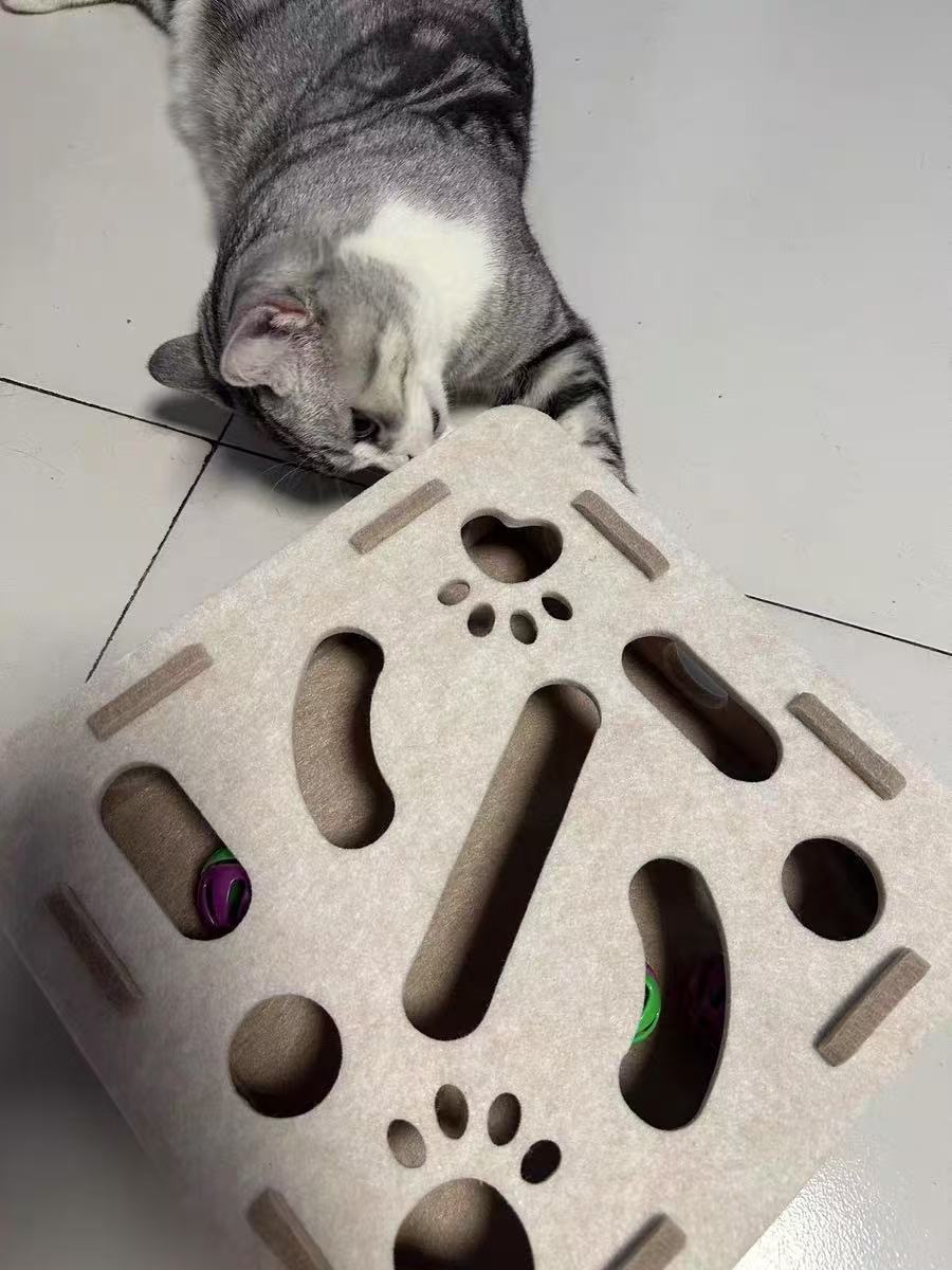 Cat playing with a Felt maze cat toy on a tiled floor