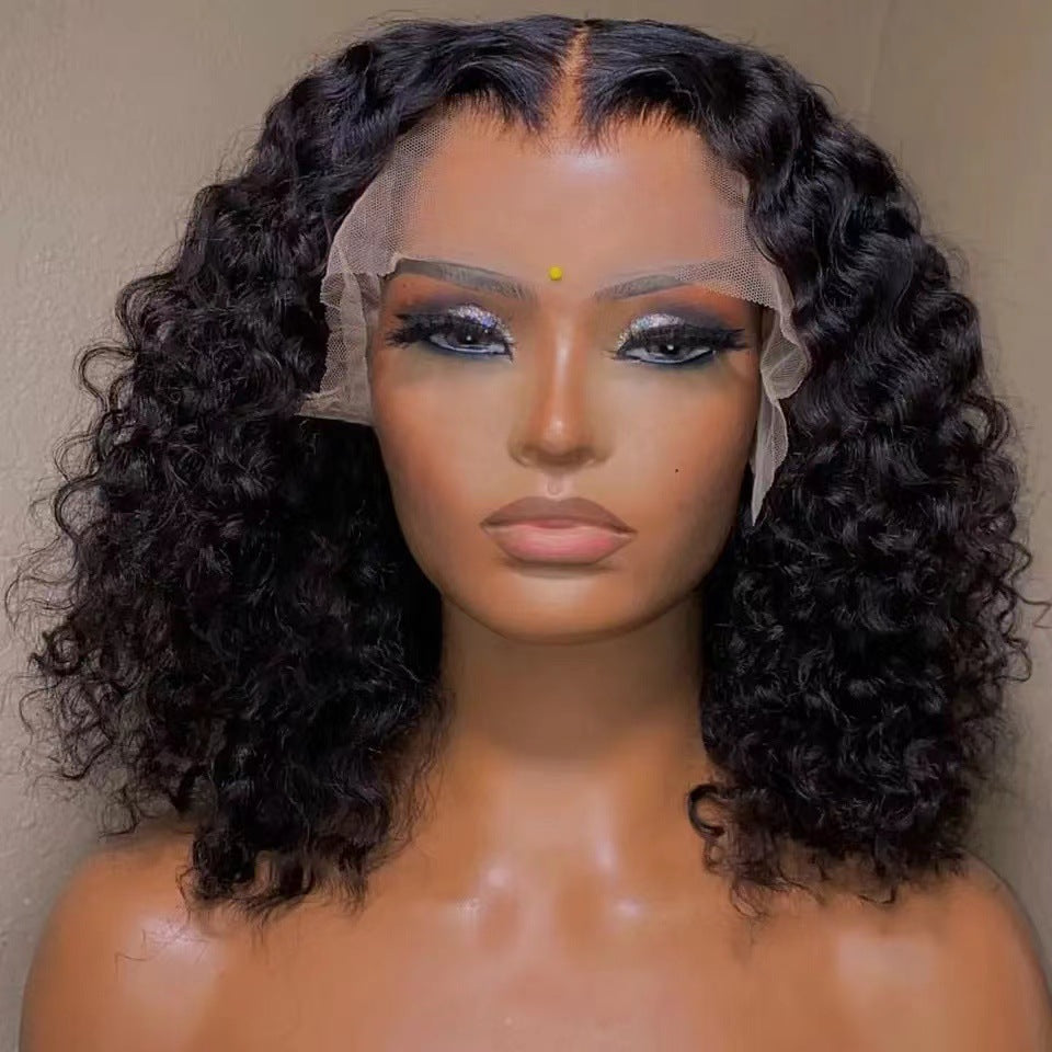 Mannequin head with curly black wig on a plain background