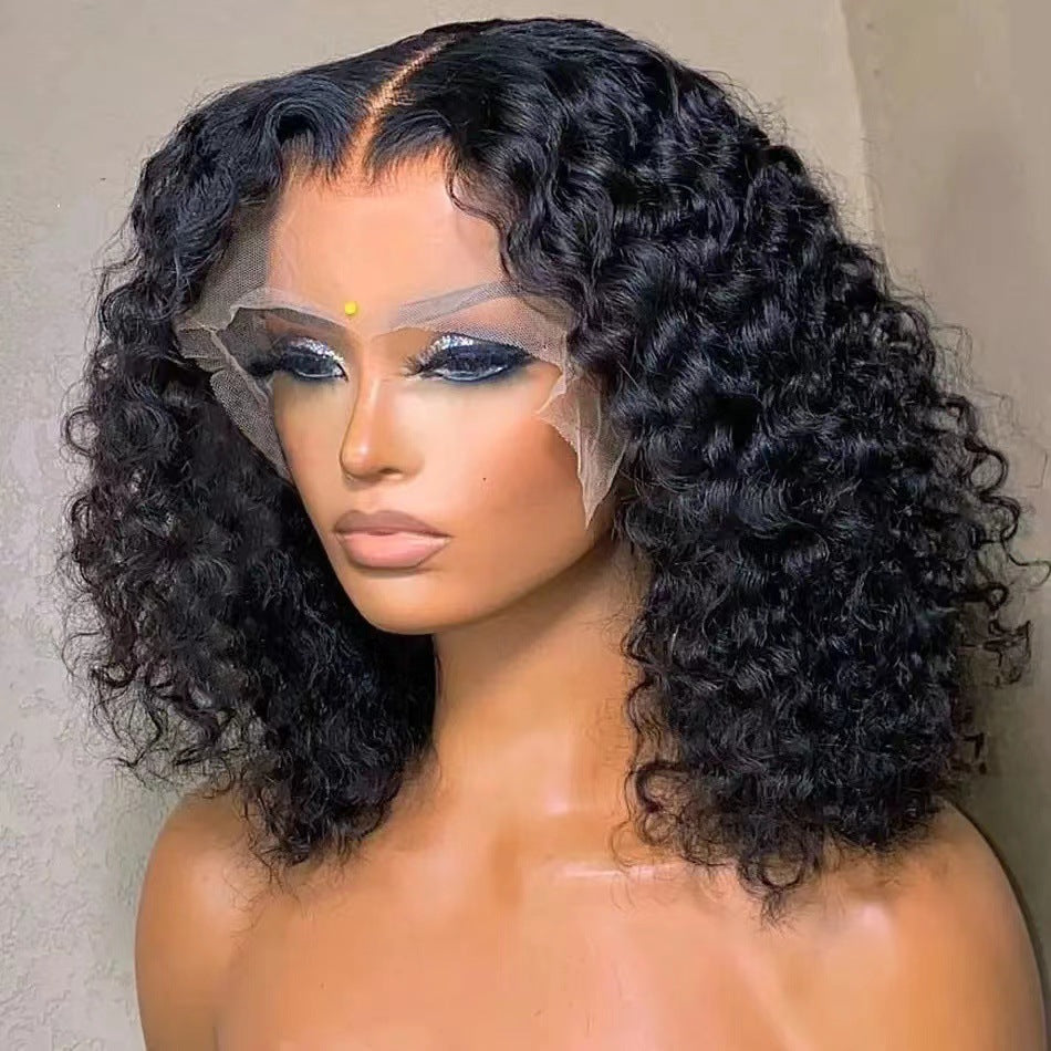 Person wearing a black curly wig with a neutral background